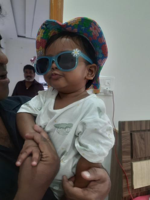 Vyomika Singh wearing a colourful hat and blue sunglasses